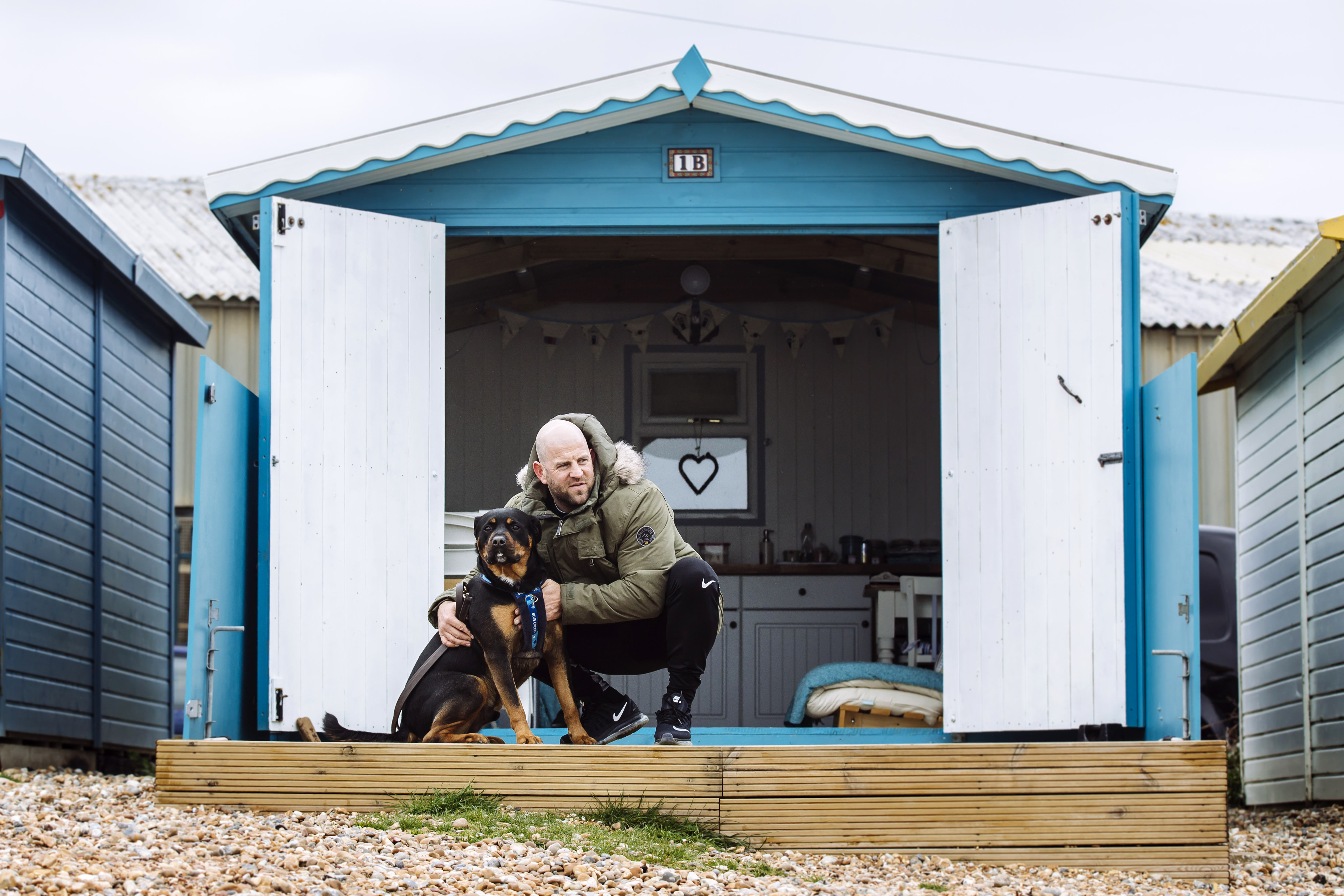 Rottweiler with owner outside a glamping spot