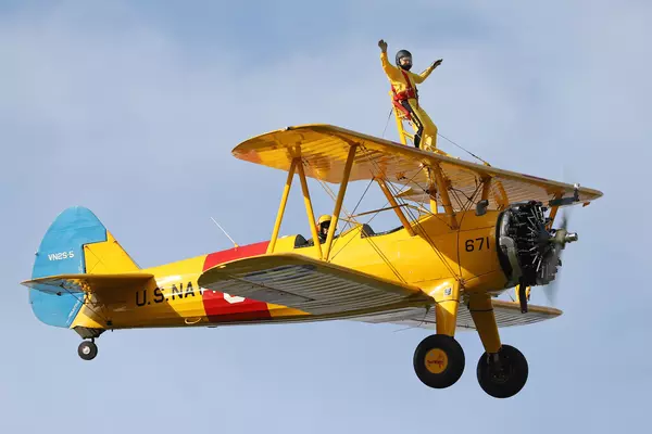 Man standing on the wing of a plane for a wingwalk challenge event 