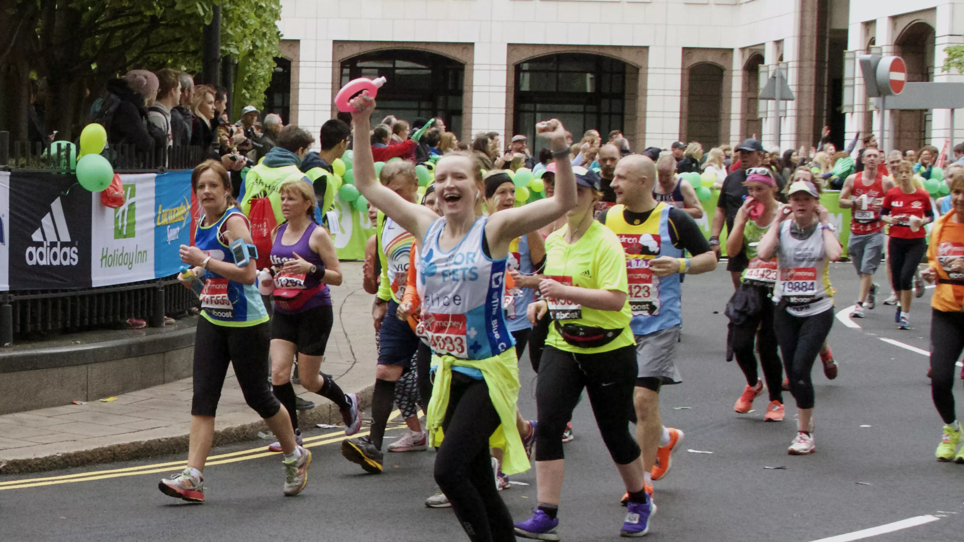 Woman cheering whilst running maraton