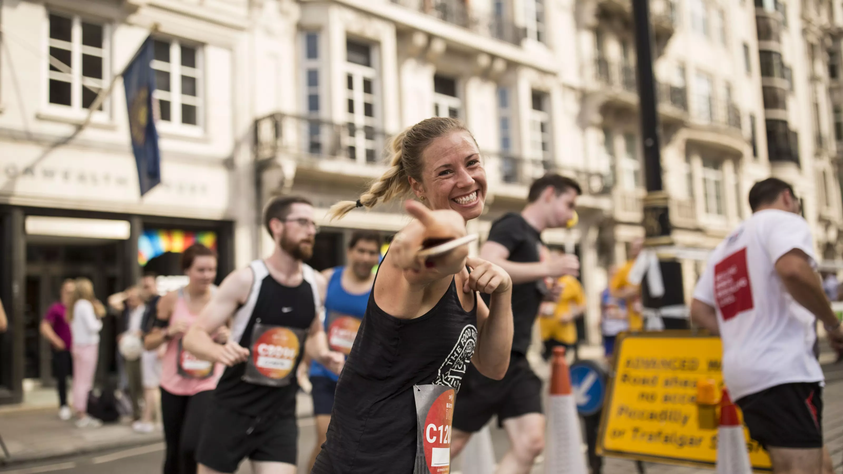 A lady running through Westminster, London, as part of the Asics London 10k race