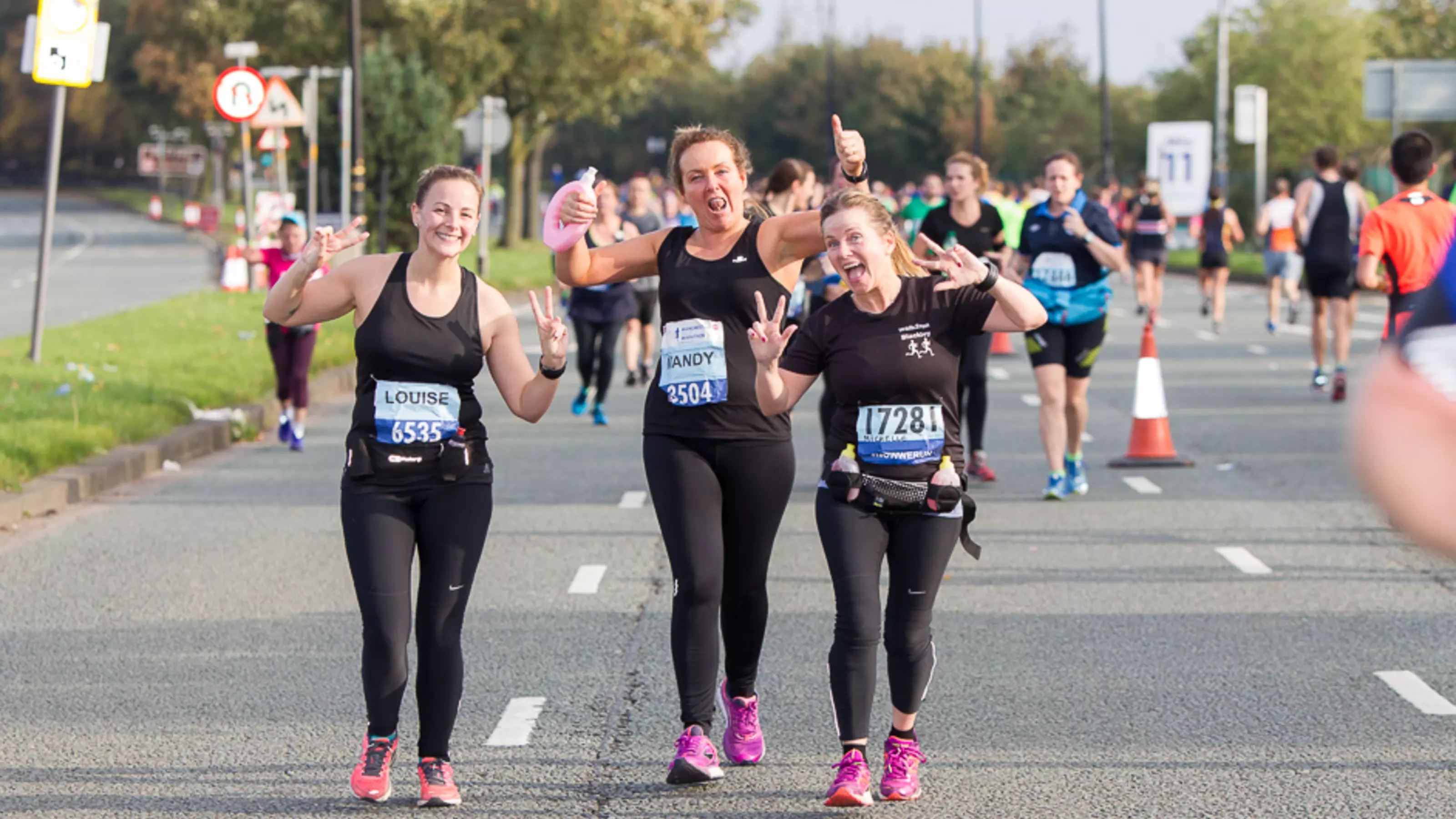 Three young women running as part of the Manchester Half marathon 