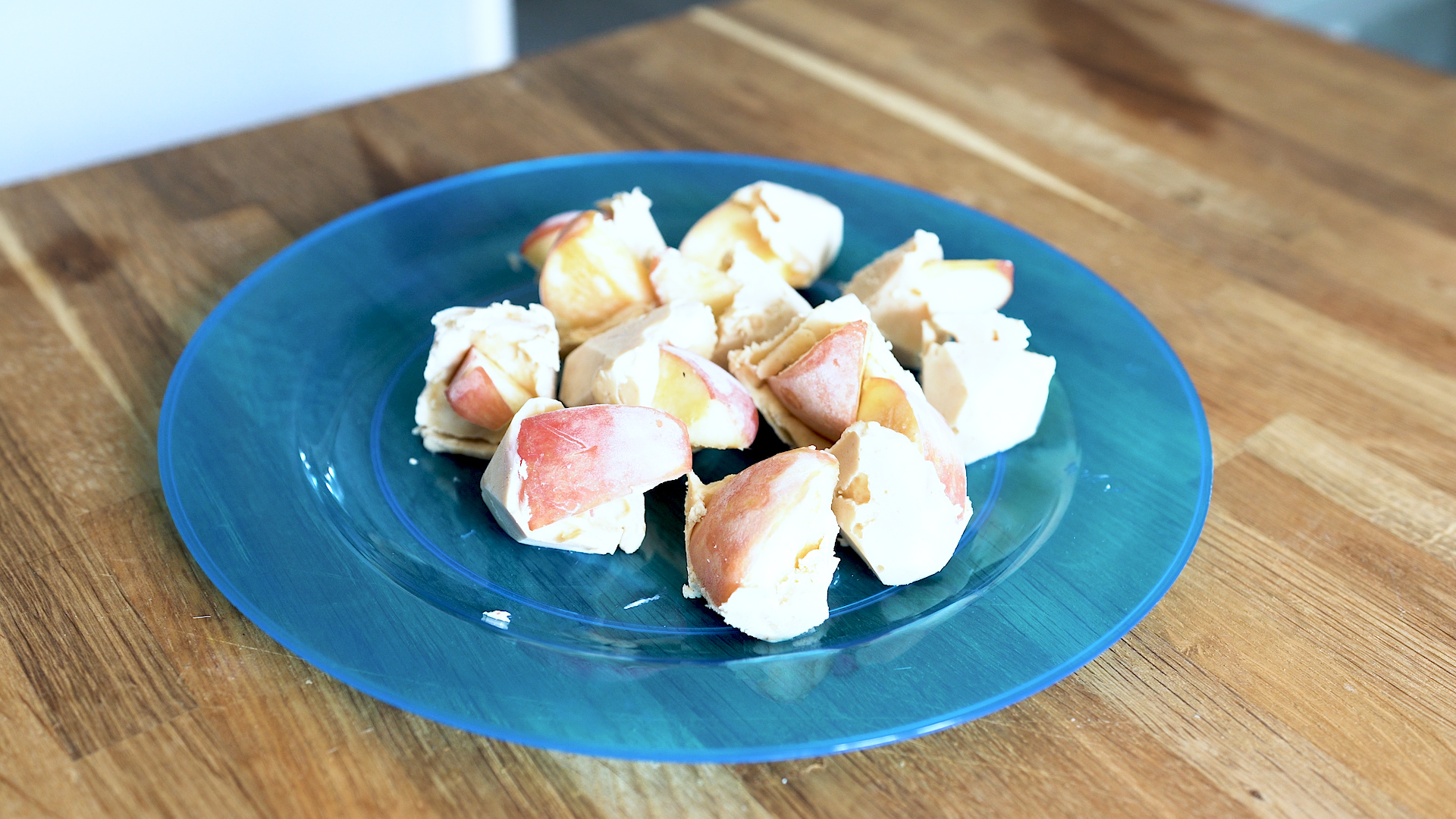 Apple and peanut butter frozen bites on a plate