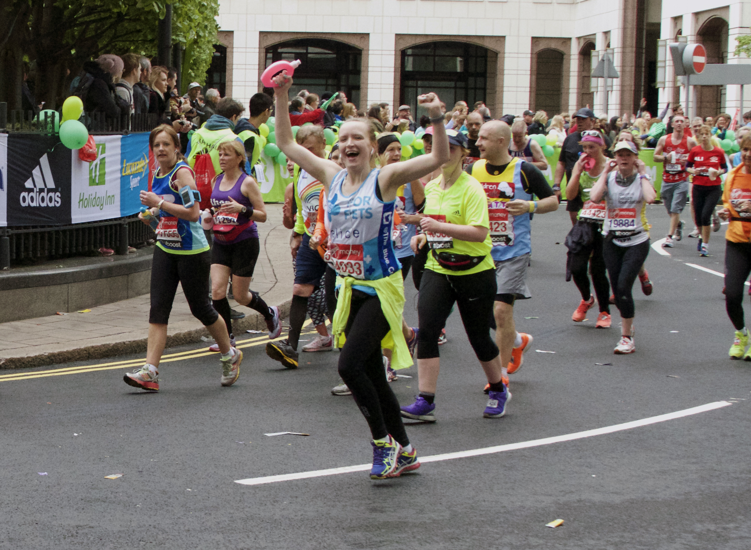 Woman cheering whilst running maraton