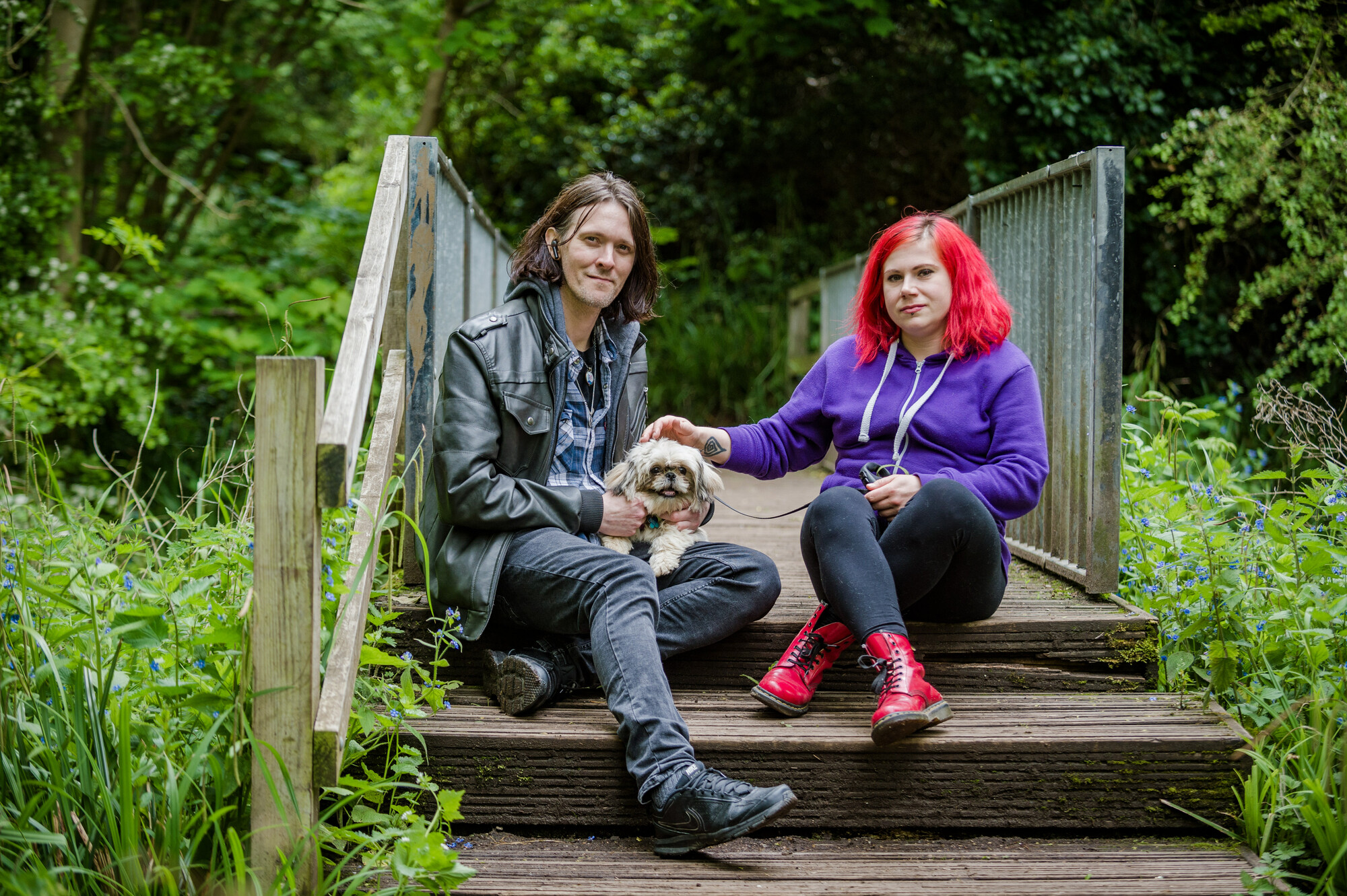 James and Monika sat on a bridge while out on a walk with Chewbie