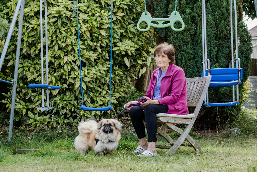 Pekinese dog Bonya stands next to his owner, Natalia, as they are reunited after four months of separation