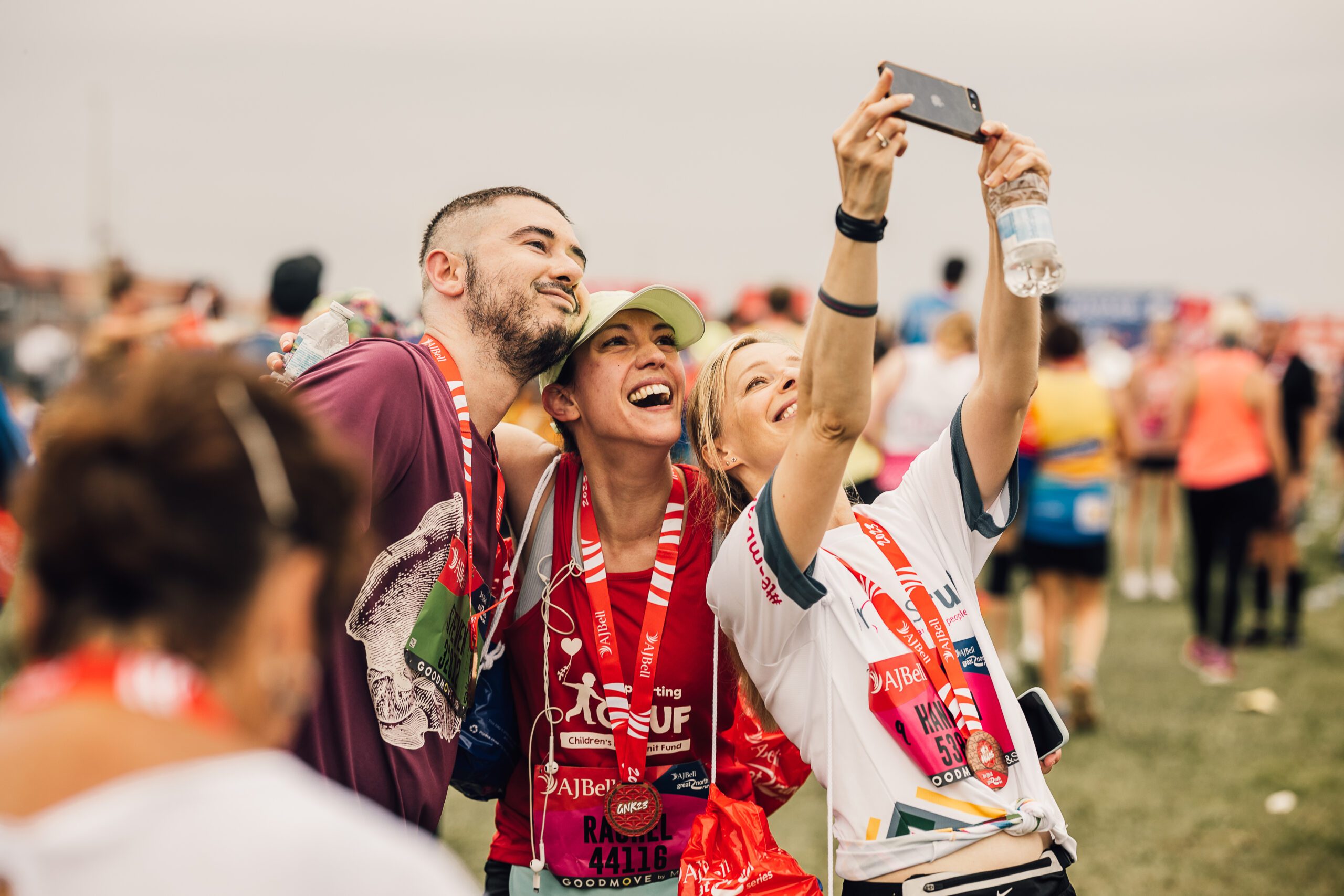 A group of runners celebrating completing the Great North Run.