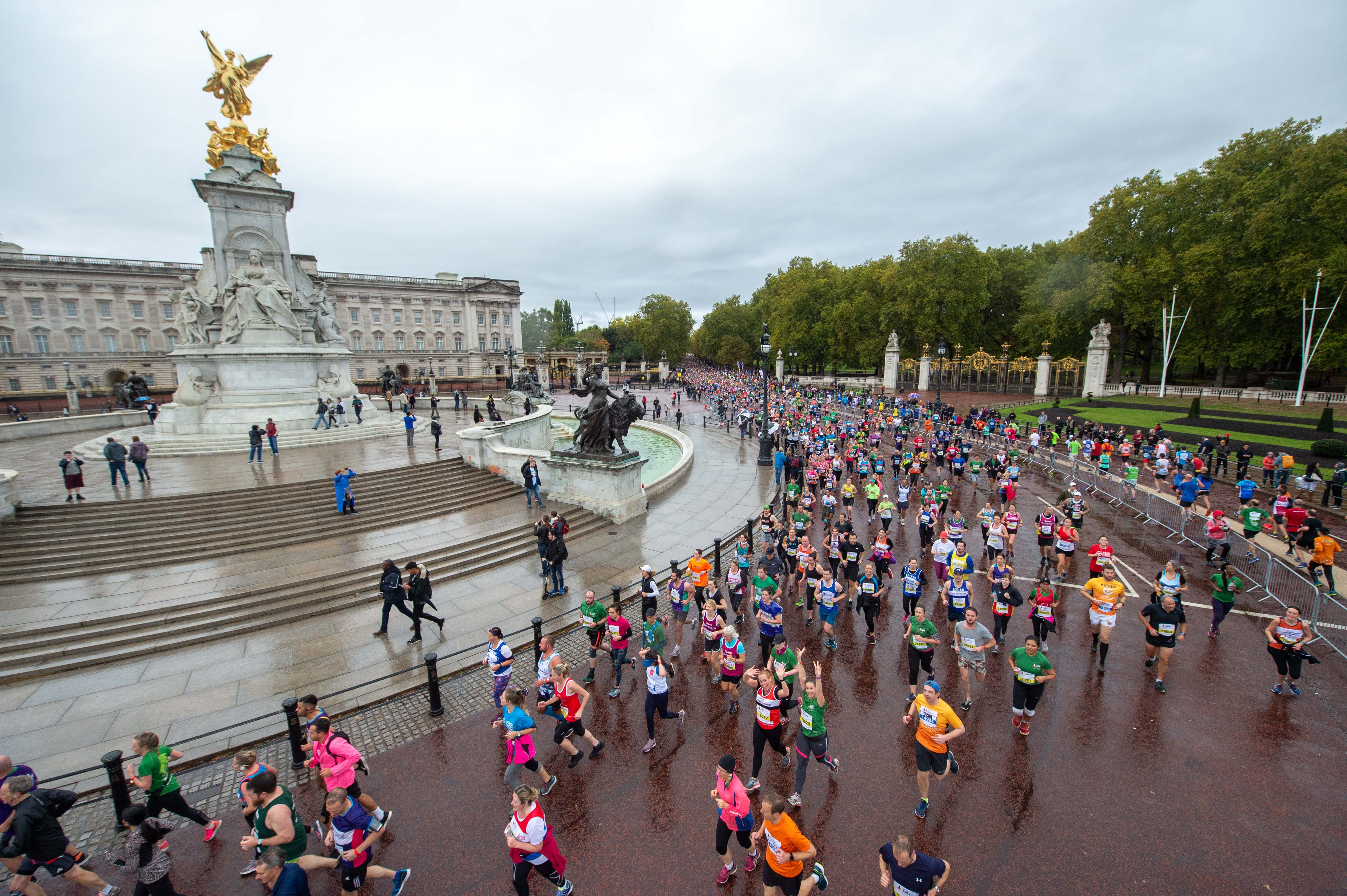 Marathon runners running past Buckingham Palace as part of the Royal Park half 