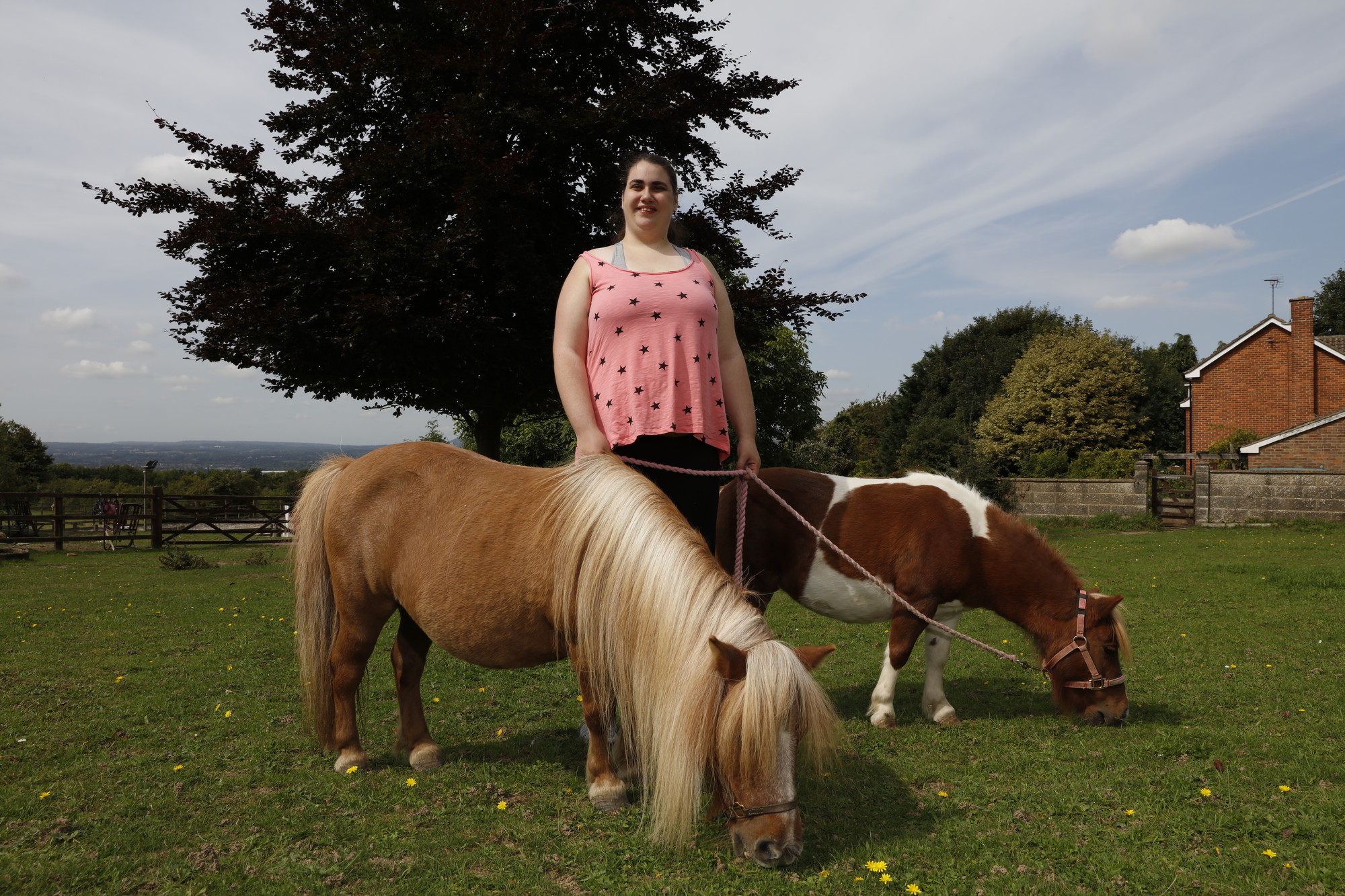 Katy holding onto the ponies on their ropes