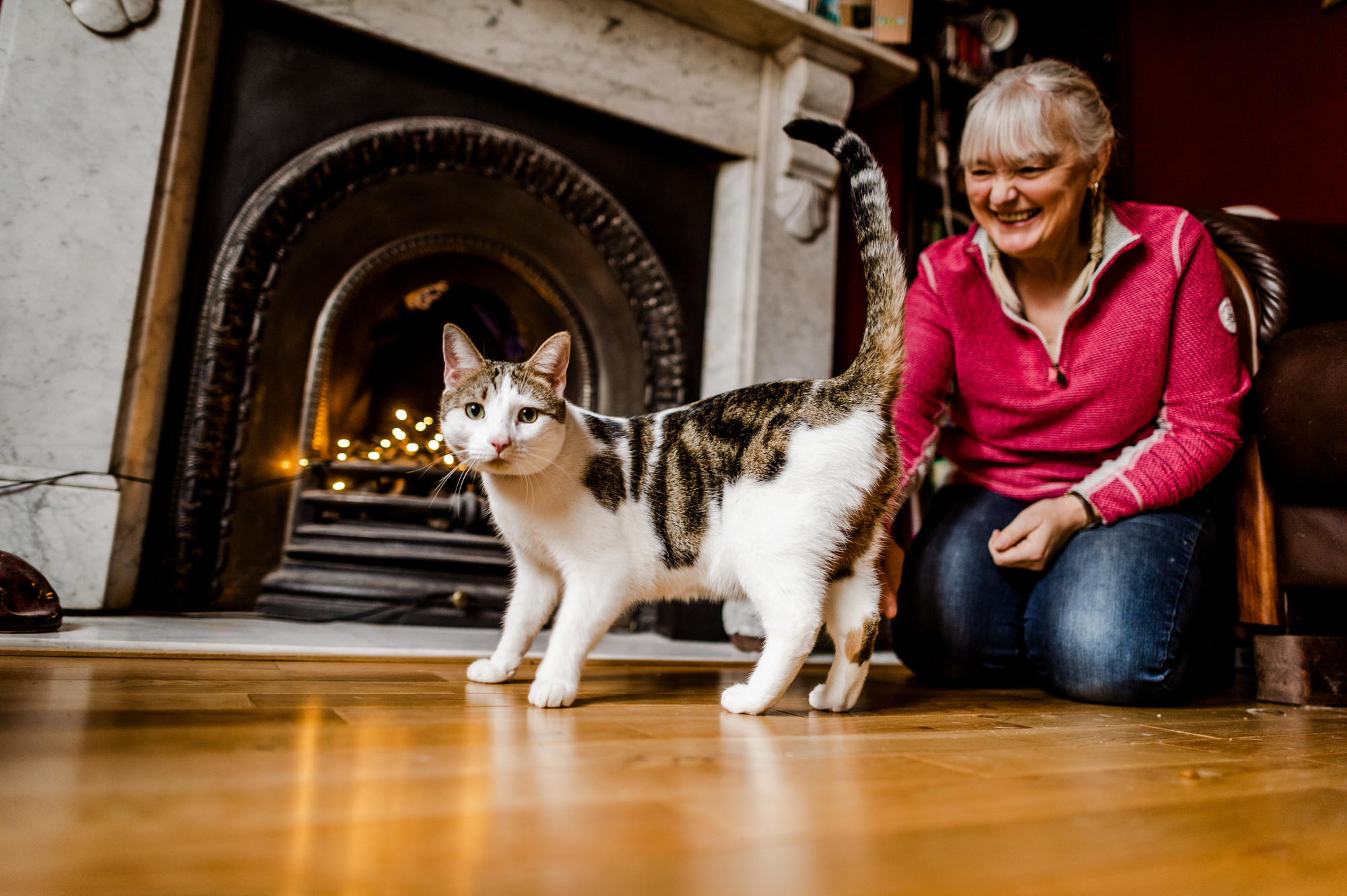 Rupert in front of fire with owner Irene