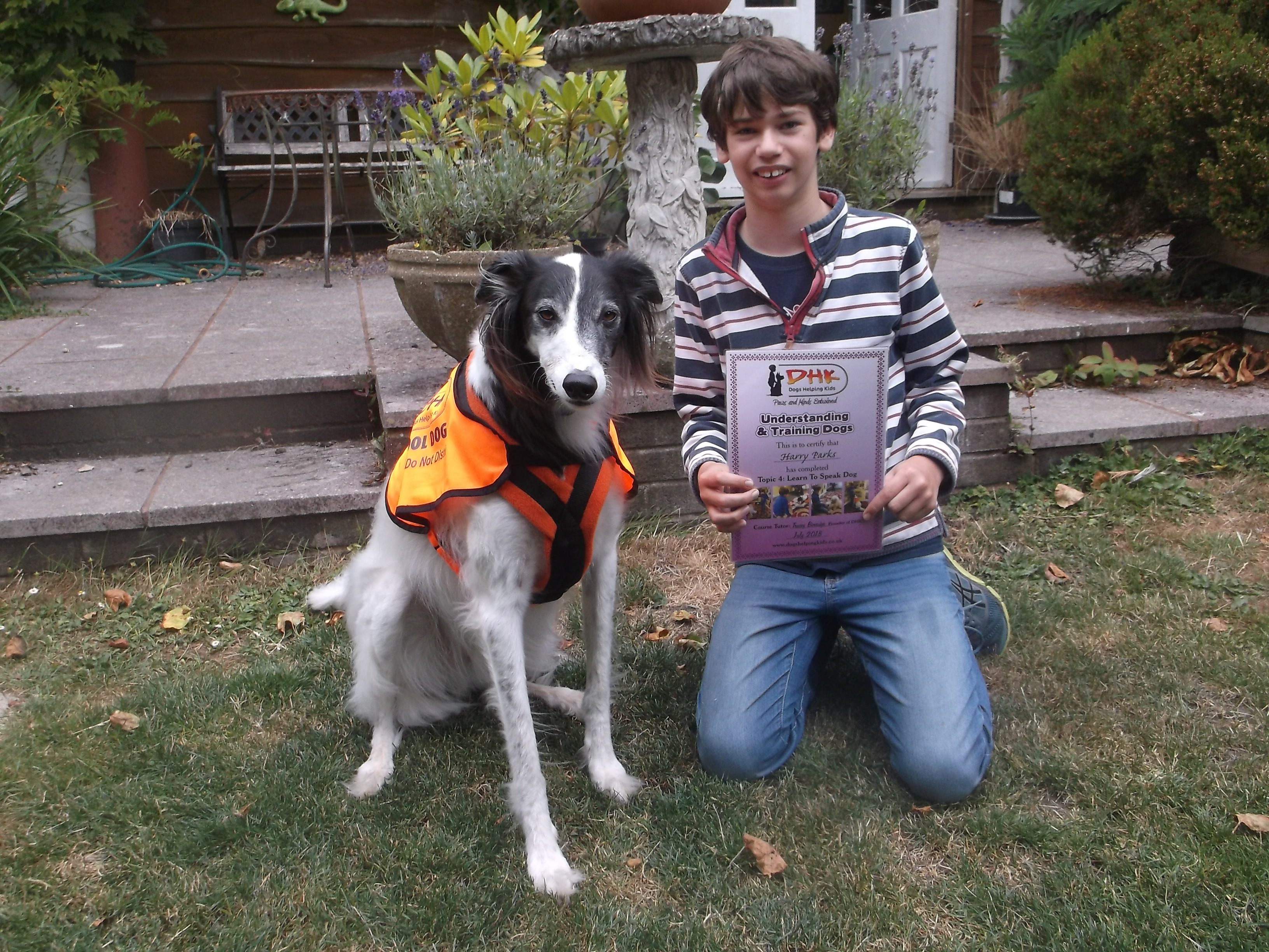 Harry holding his dog ownership certificate with Vader