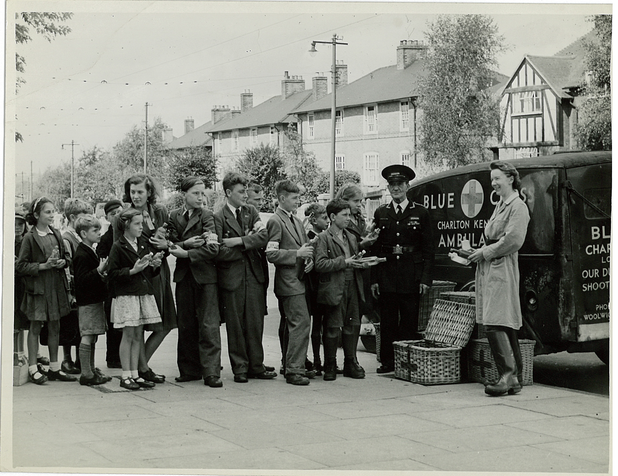 People line up outside a Blue Cross ambulance in the Second World War