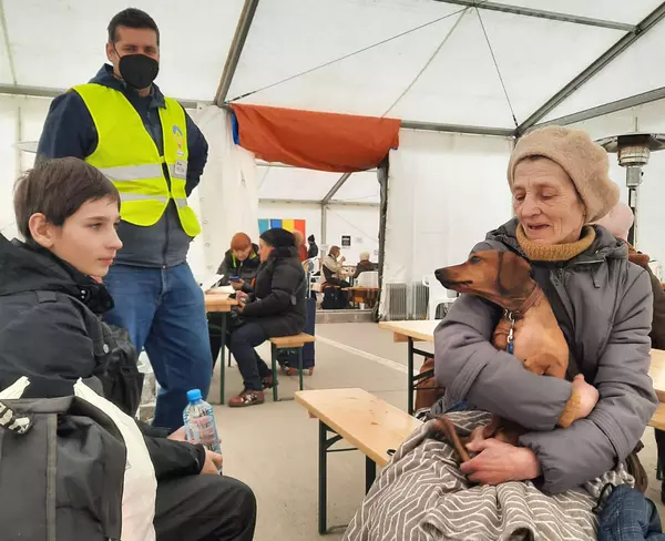 Odessa being held by the grandmother in a tent to help Ukrainian refugees