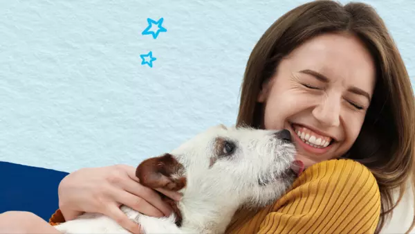 Puppy licking lady's face