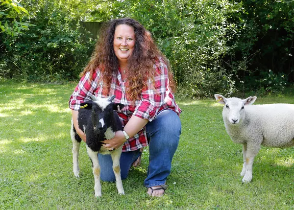 Blue Cross Trustee Beth Brook with her pet goat and lamb, Star and Splints