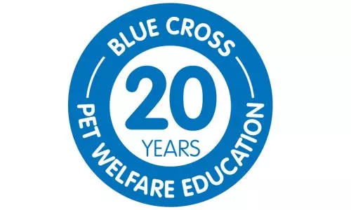 A blue and white logo with a roundel that reads 'Blue Cross, 20 years, pet welfare education' 