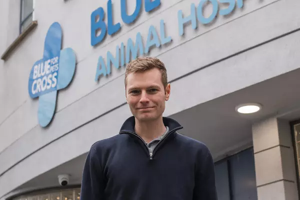 Headshot of Ben Simpson-Vernon, Celebrity Blue Cross Ambassador, standing in front of our Blue Cross animal hospital in Victoria