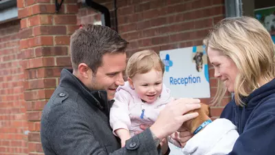 Couple with child introducing puppy