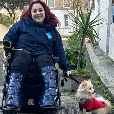 General Hospital Assistant Freya Walker poses for a photo with a chihuahua.