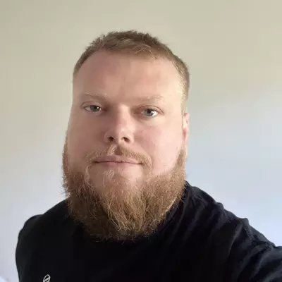 A headshot of Scott King, regional fundraising officer for the South of England and Wales. Scott is looking into the camera and wearing a black t-shirt.