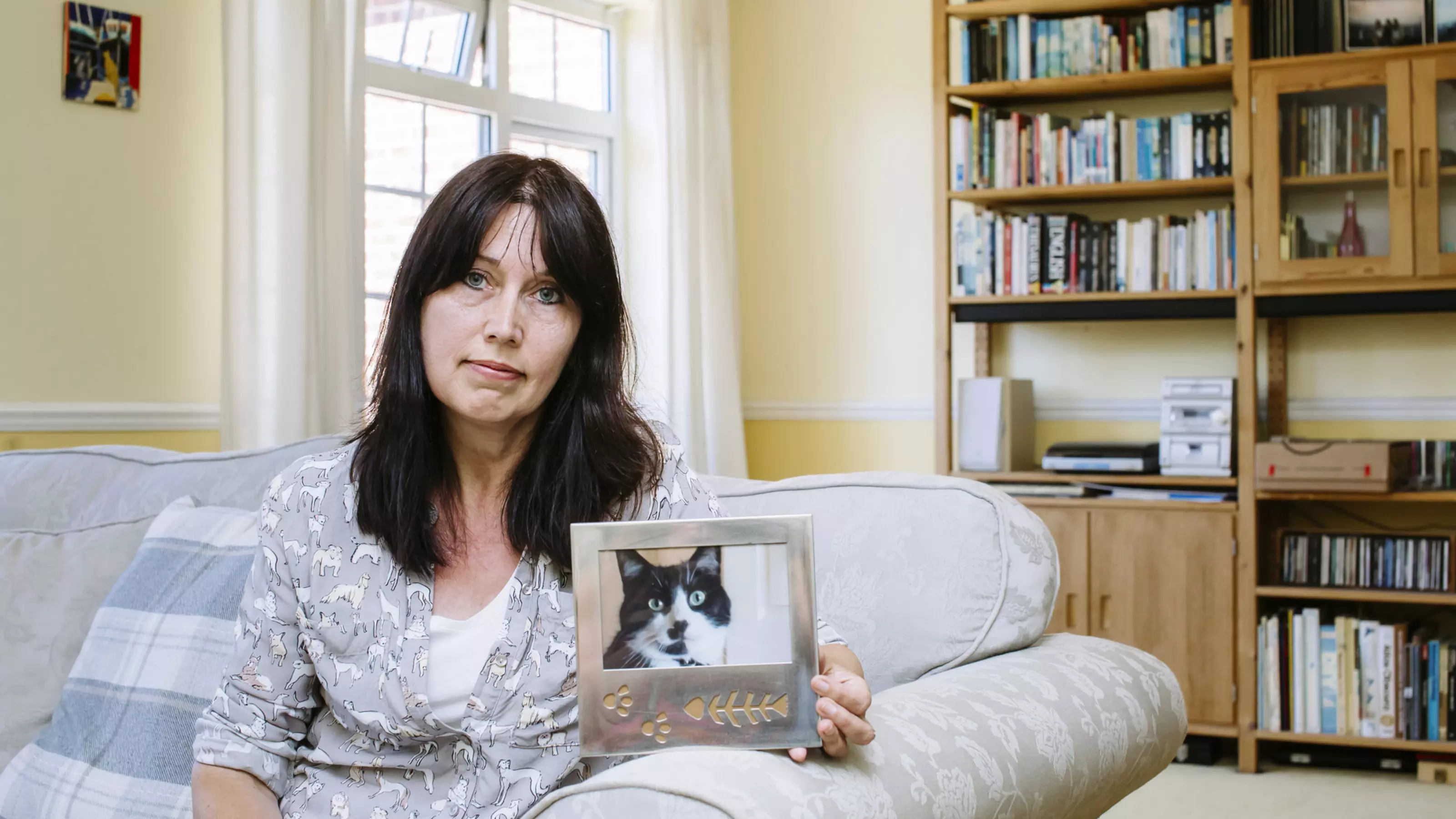 Jackie Buckle holding photo of cat Max