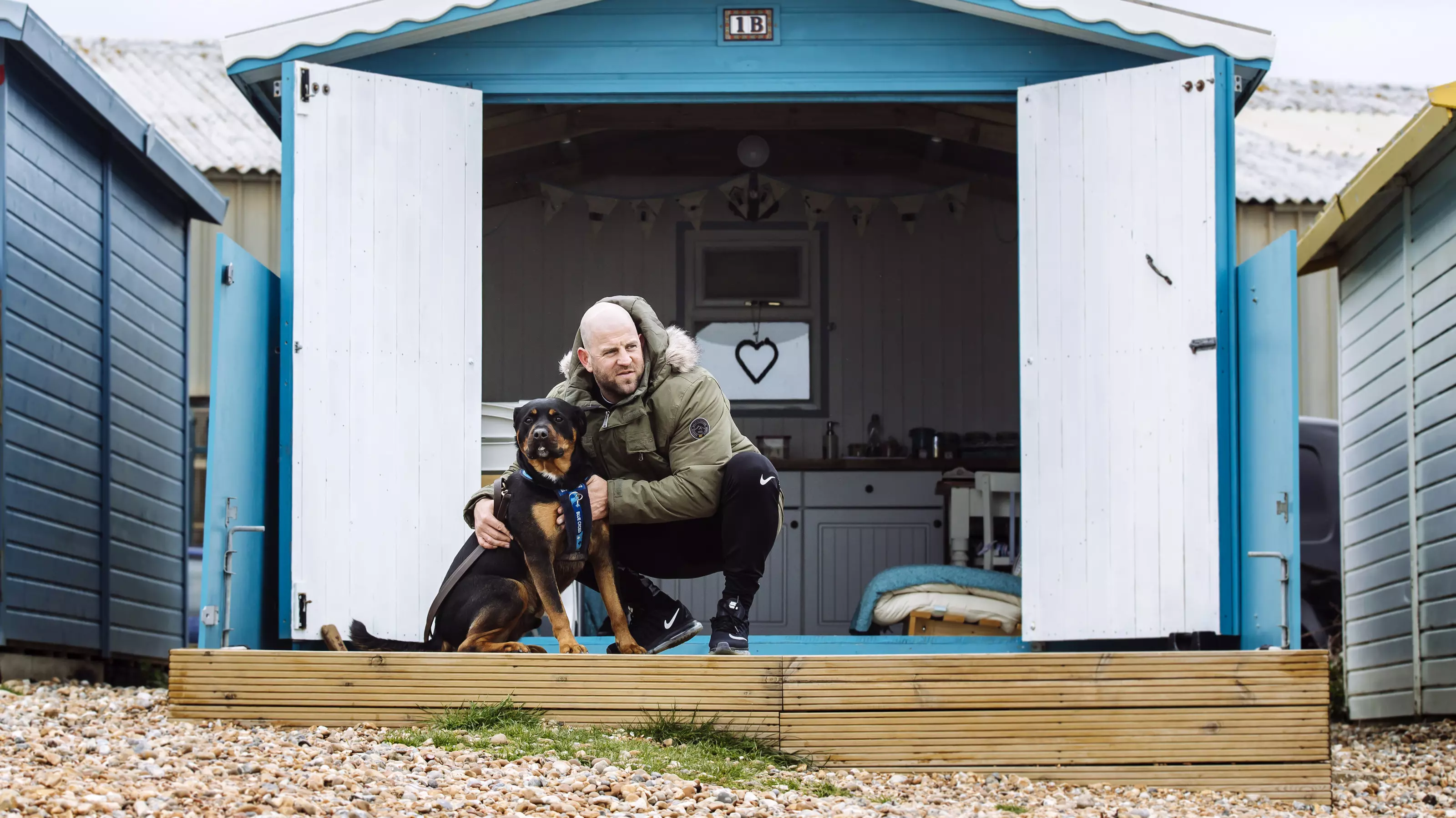 Rottweiler with owner outside a glamping spot