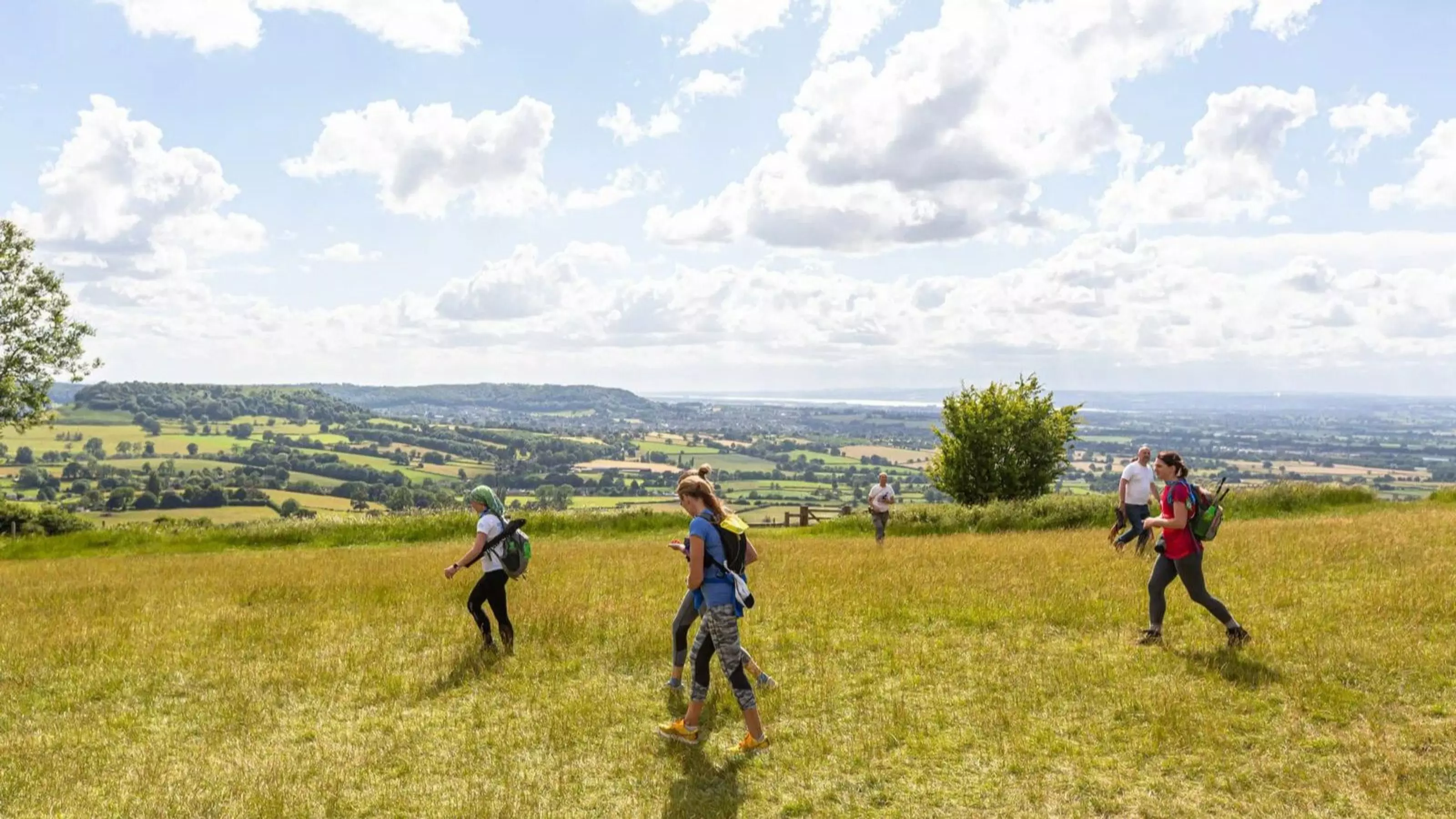 Peak District Challenge walkers walking over a hill.