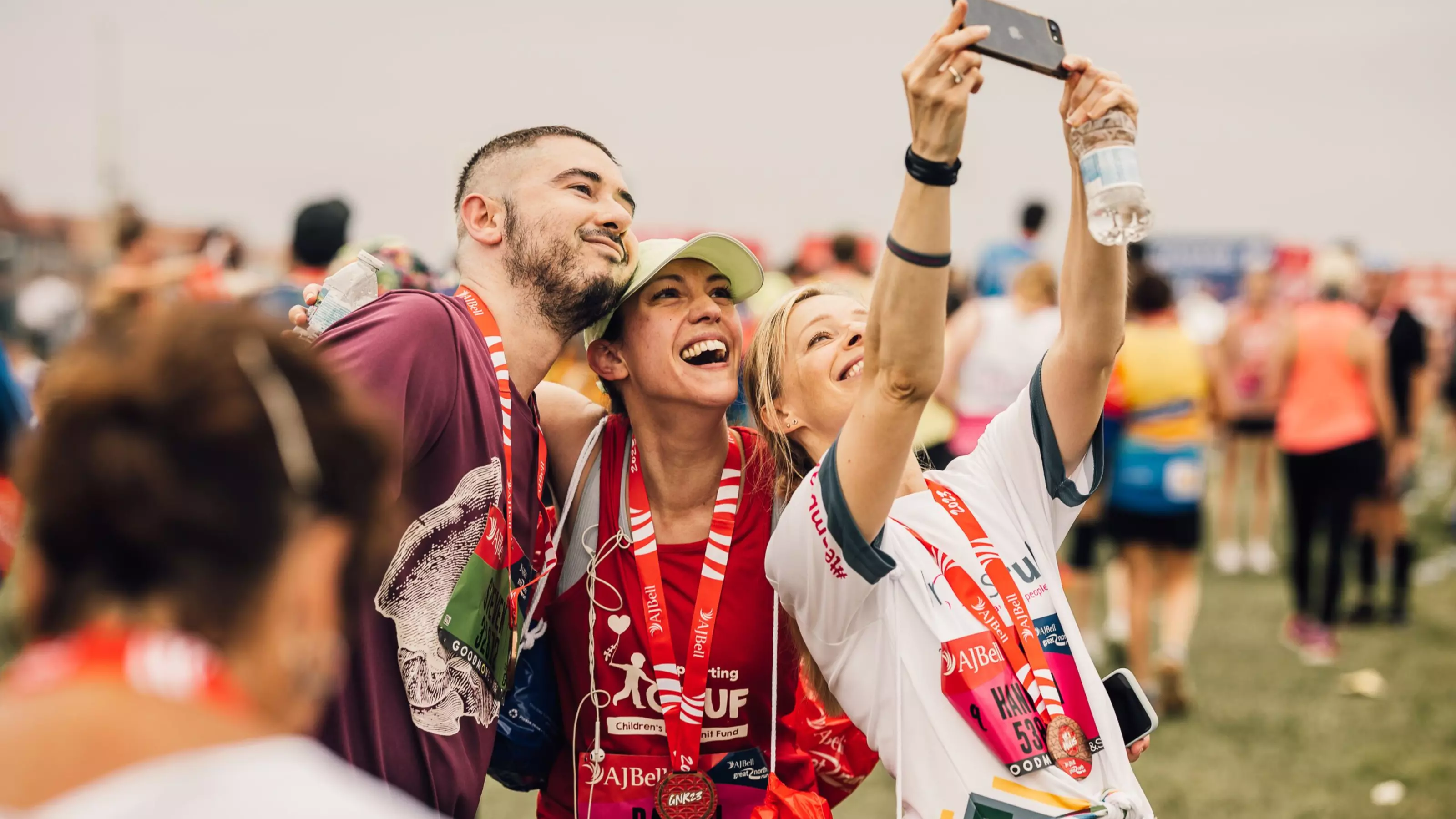A group of runners celebrating completing the Great North Run.