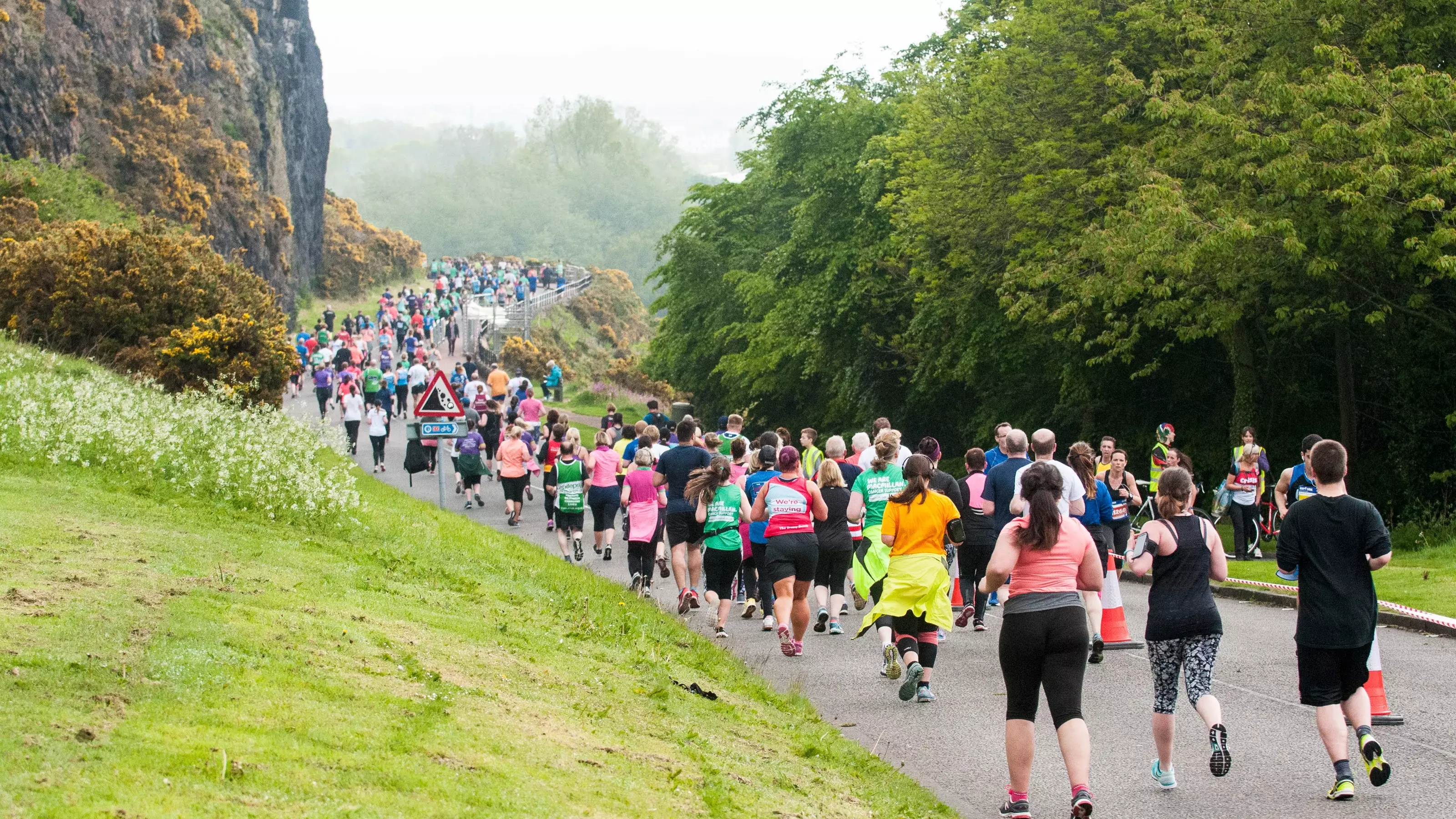 An image showing runners running through Edinburgh as part of the Edinburgh Half Marathon