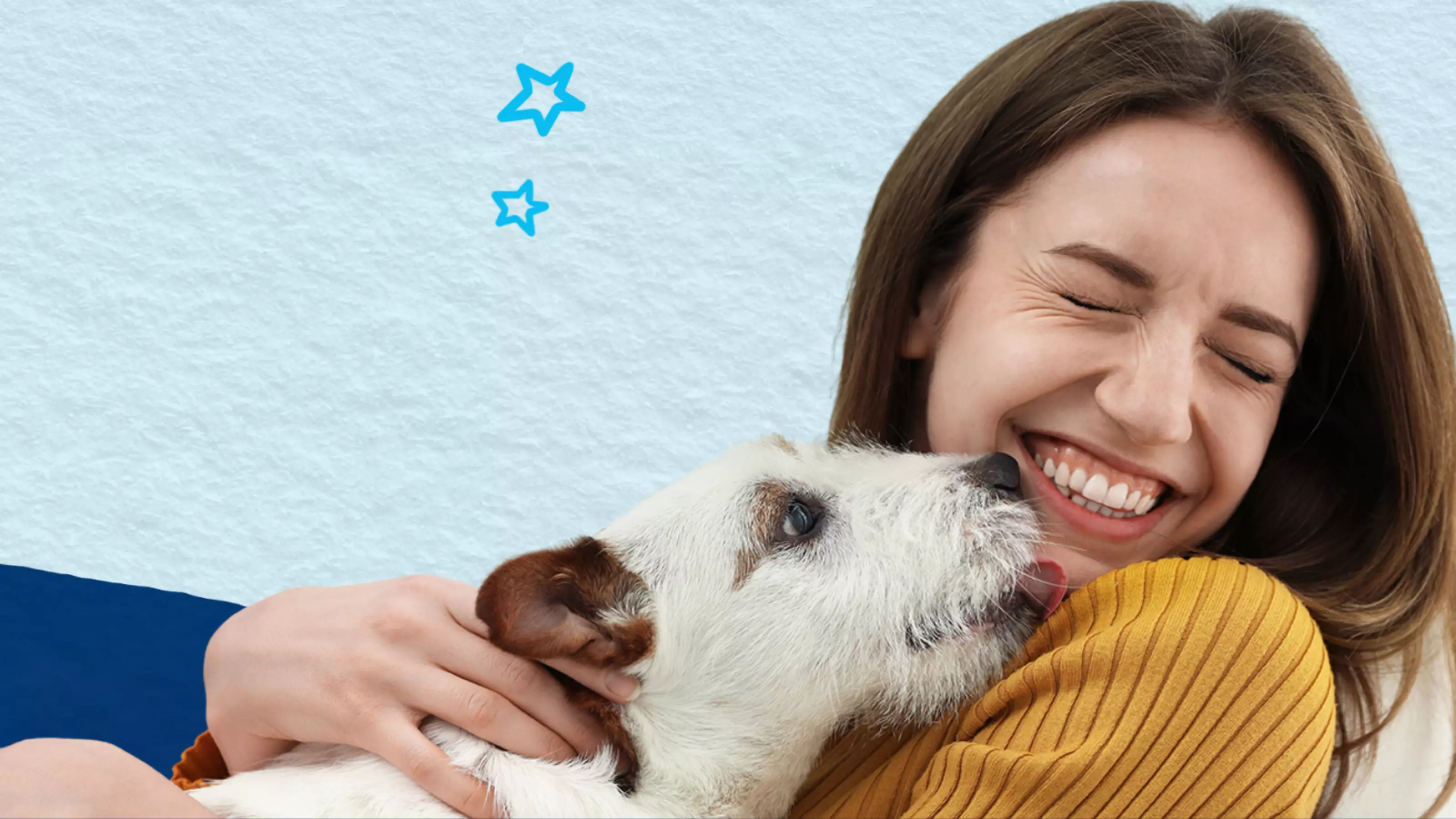A lady smiles as a jack russell licks her face. Behind them is a blue background and illustrated stars.