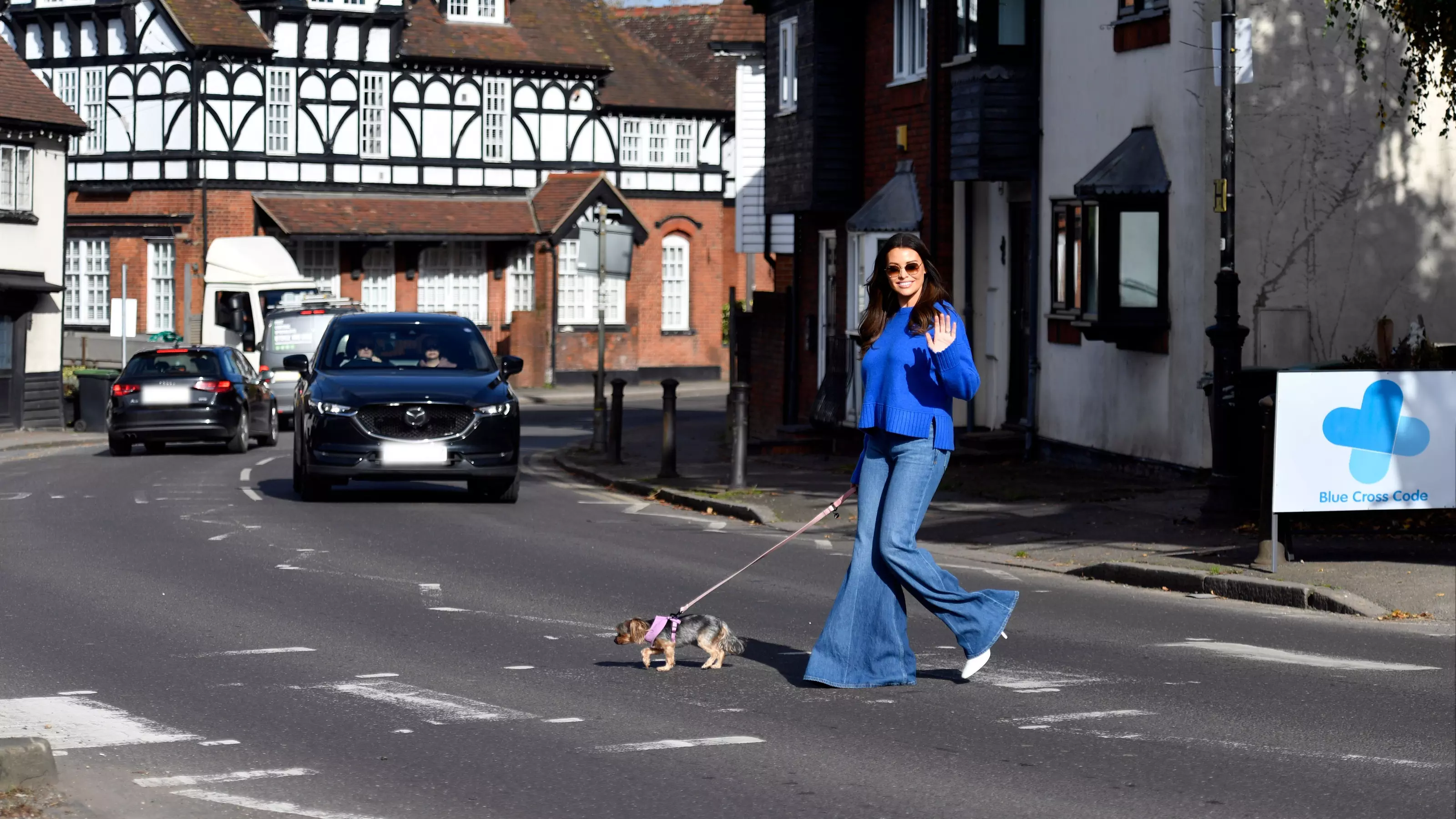Jess Wright crossing the road with her dog