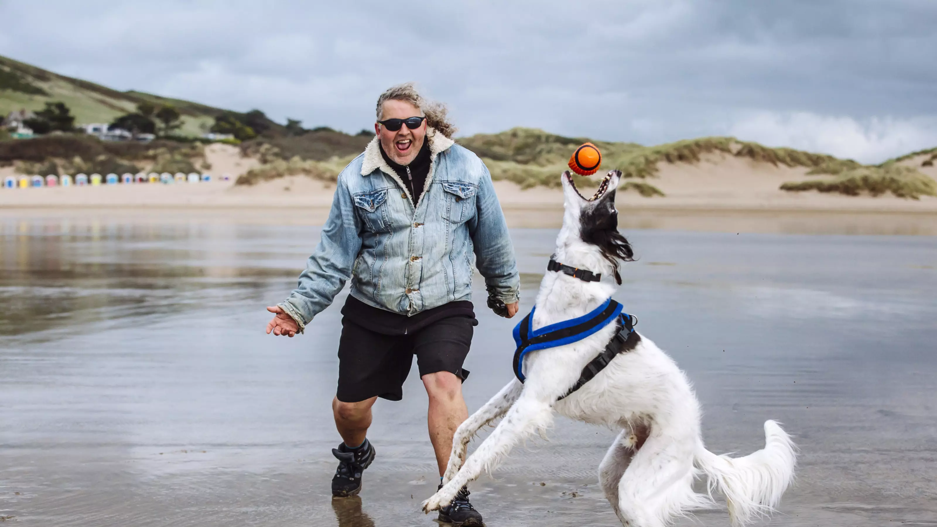 Vader with Mark on the beach playing ball
