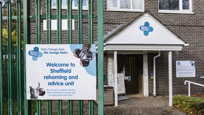 A brown bricked building with a Blue Cross sign reading 'Welcome to Sheffield rehoming and advice unit'