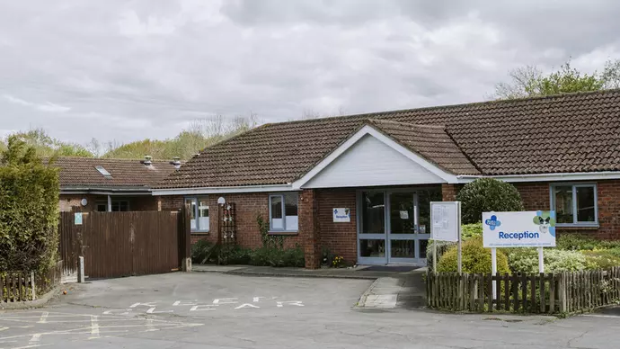 A brick building with a car park
