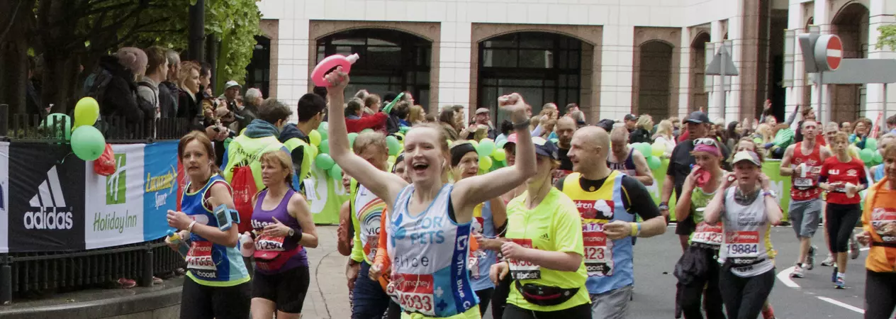 Woman cheering whilst running maraton