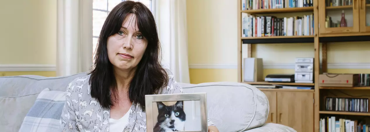 Jackie Buckle holding photo of cat Max