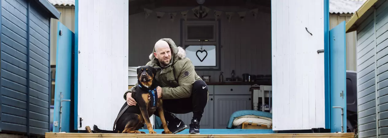 Rottweiler with owner outside a glamping spot