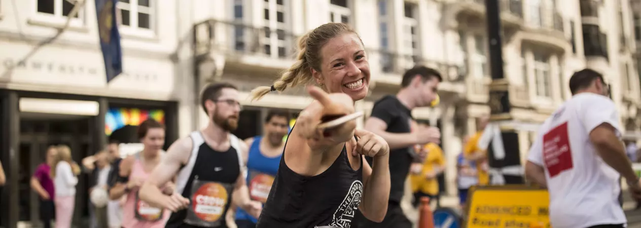 A lady running through Westminster, London, as part of the Asics London 10k race