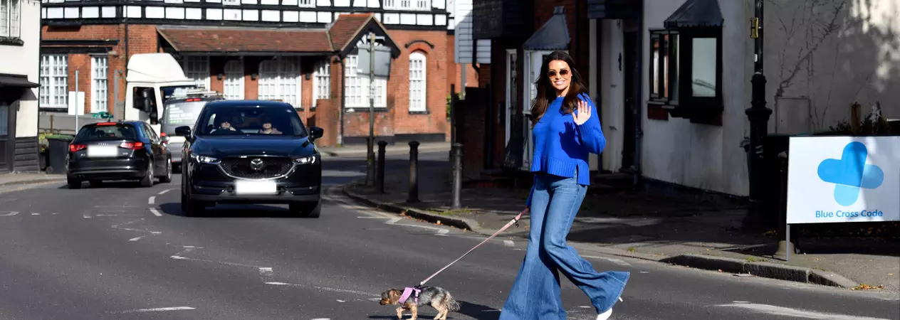 Jess Wright crossing the road with her dog