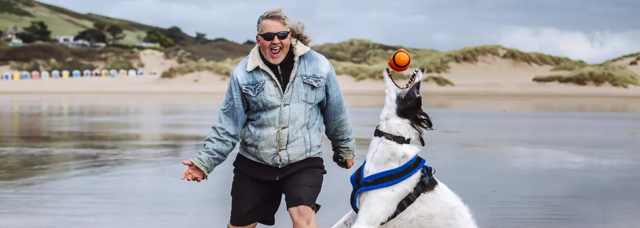 Vader with Mark on the beach playing ball